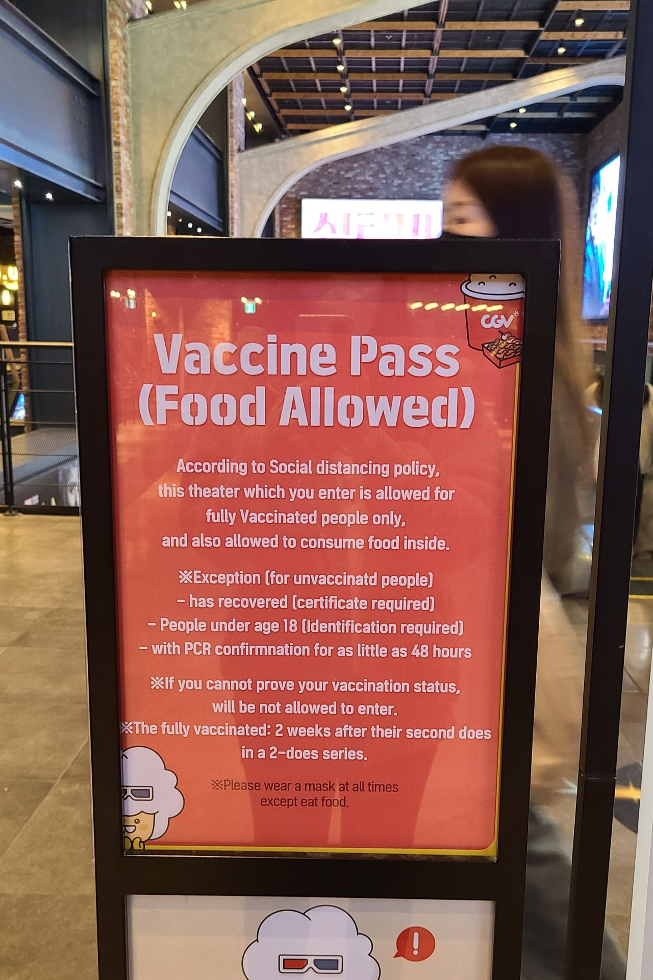 A sign at CGV Yongsan in central Seoul explains the rules for the vaccine-pass auditorium. (Song Seung-hyun/The Korea Herald)