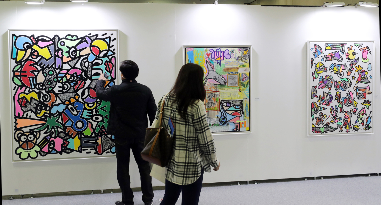 People look at art pieces displayed at NFT Busan on Thursday. (Yonhap)