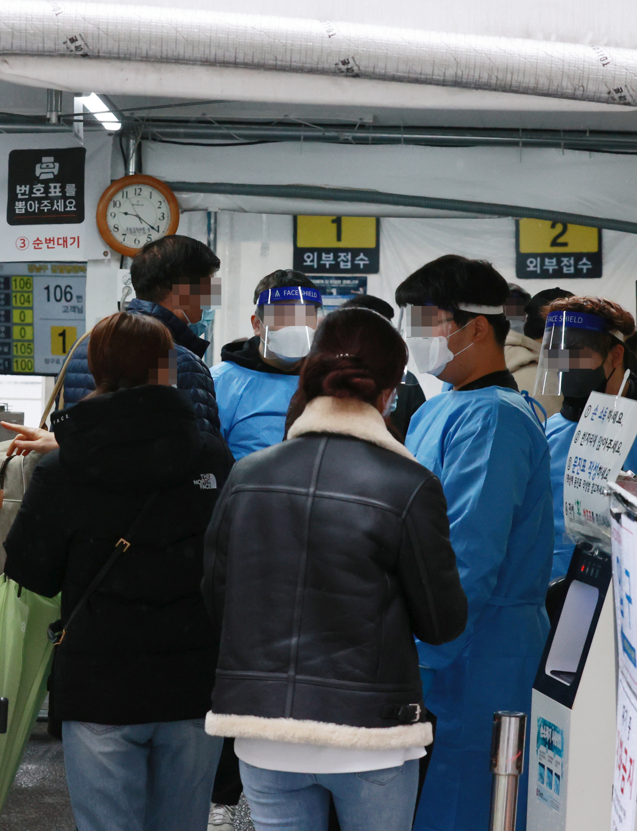 People visit a screening clinic in Seoul's Gangnam Ward on Tuesday, to receive coronavirus tests. South Korea's new coronavirus cases stayed below 2,000 for the second straight day, but health authorities remain on alert over a possible spike in new infections under eased virus curbs. (Yonhap)