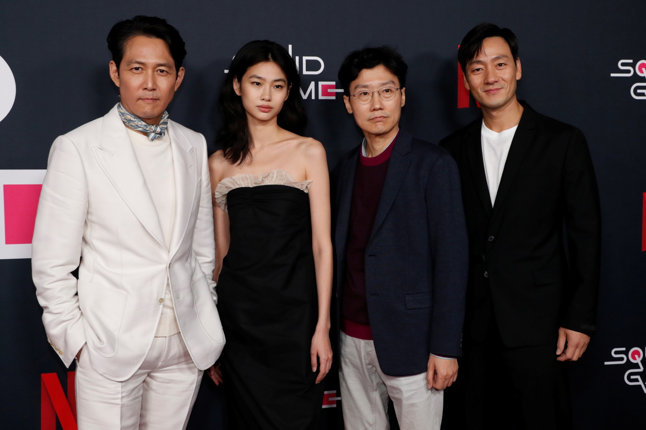 caption: From left: Actors Lee Jung-jae, Jung Ho-yeon, director Hwang Dong-hyuk and actor Park Hae-soo pose for photos at Netflix’s red carpet event in Los Angeles on Tuesday. (Reuters-Yonhap)