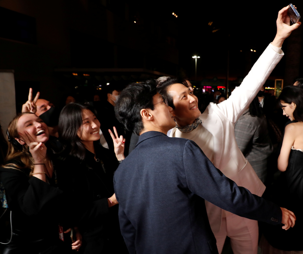 Director Hwang Dong-hyuk and actor Lee Jung-jae take photos with the fans at Netflix’s red carpet event. (Reuters-Yonhap)