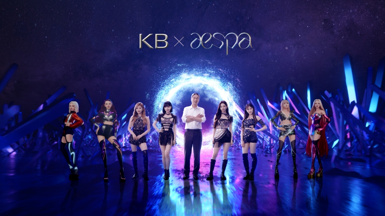 KB Kookmin Bank CEO Hur Yin (center) poses with K-pop girl group aespa and their four virtual avatar members in a teaser video released by the bank on Sept. 30. (KB Kookmin Bank)