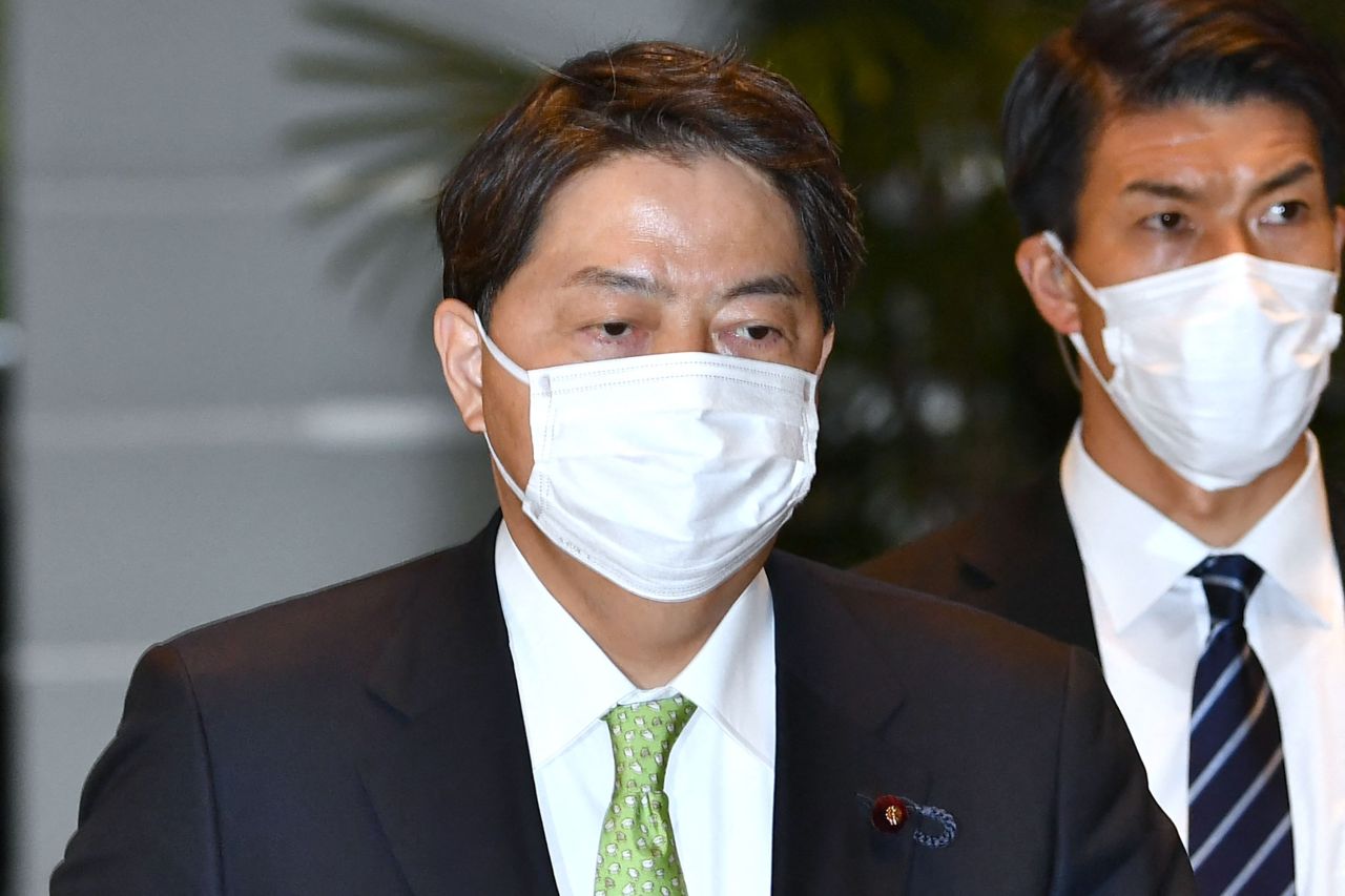 Yoshimasa Hayashi (left), Japan`s new foreign minister, arrives at the prime minister`s office in Tokyo on Wednesday. (AFP-Yonhap)