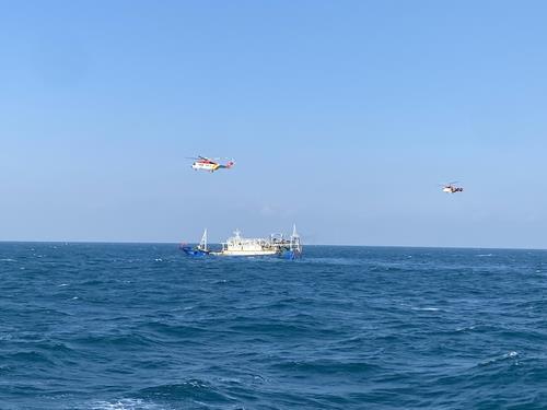 This photo provided by the Yeosu Coast Guard on Friday, shows a rescue operation of sailors from a sinking Chinese fishing boat in the southern waters of South Korea. (Yeosu Coast Guard)