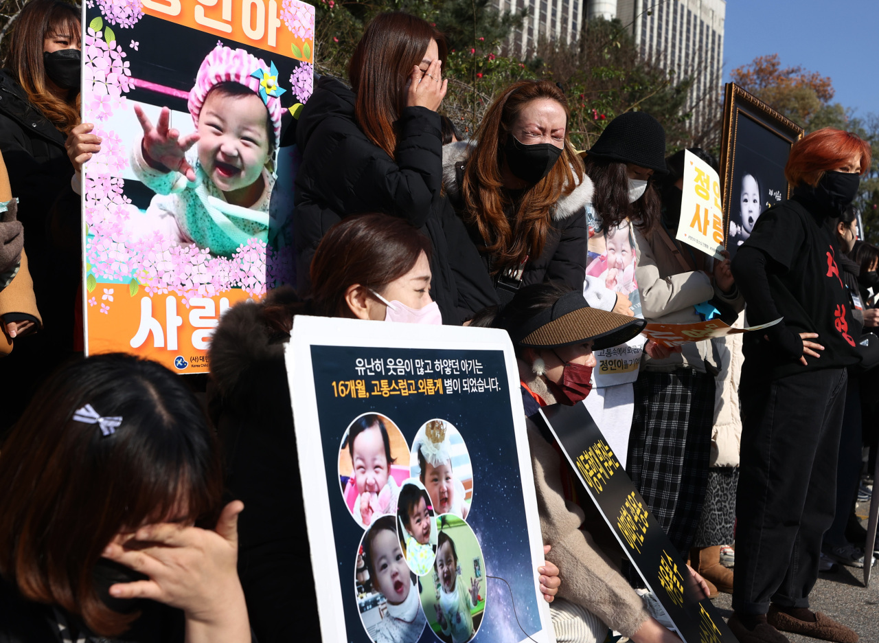 Activists from child abuse prevention organizations lamented the appellate court ruling that commuted a life sentence for an adoptive mother who murdered her toddler daughter to a 35-year prison term, in front of Seoul High Court in Seoul on Nov. 26. (Yonhap)
