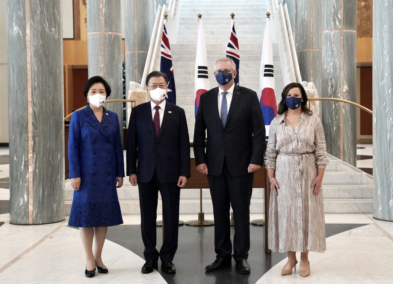 South Korean President Moon Jae-in (2nd from L) and his wife pose with Australia's Prime Minister Scott Morrison (2nd from R) and his wife after arriving at the Parliament House in Canberra on Dec. 13, 2021. Moon arrived in Australia the previous day for a four-day state visit. (Yonhap)