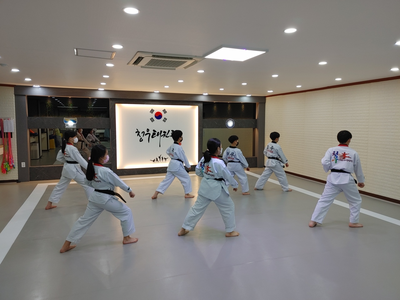 Students practice taekwondo at a class in Gyeonggi Province. (Chungwoo Taekwondo School)