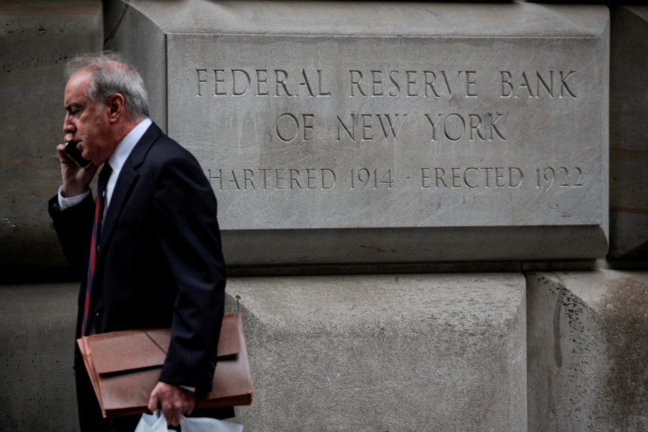 A man walks outside the Federal Reserve Bank of New York in New York City, US, October 12, 2021. (Reuters)