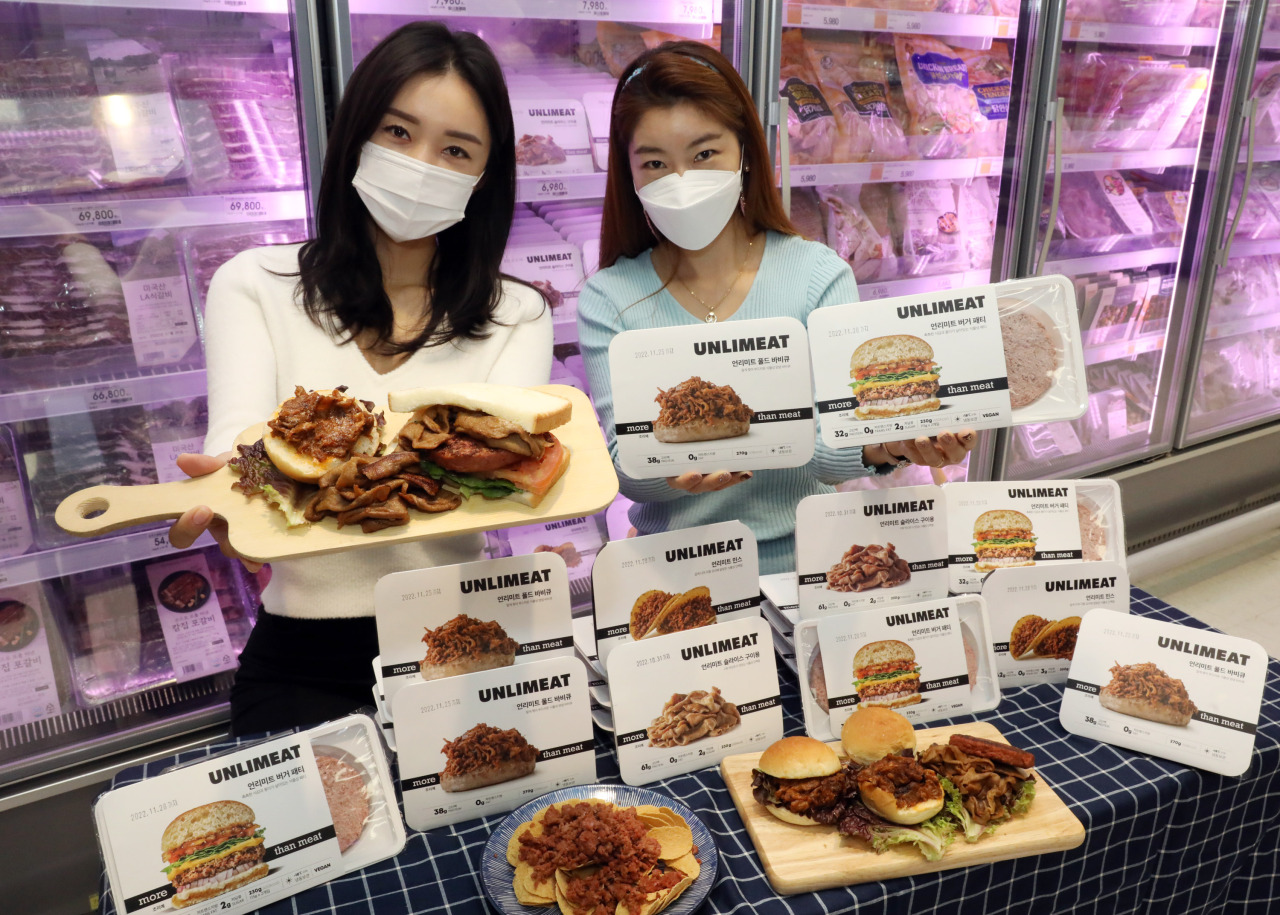 Models pose with Unlimeat meat replacement products, which was made available at Emart stores starting early December. (Yonhap)