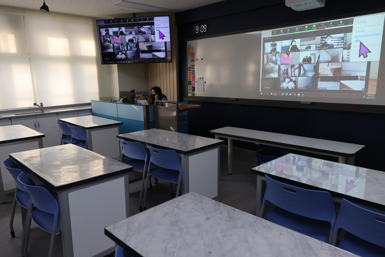 A teacher conducts an online class at a classroom of Jangwi Middle School in Seoul on Monday, when the country entered a two-week period of strong social distancing rules amid the resurgence of the coronavirus, ending the 