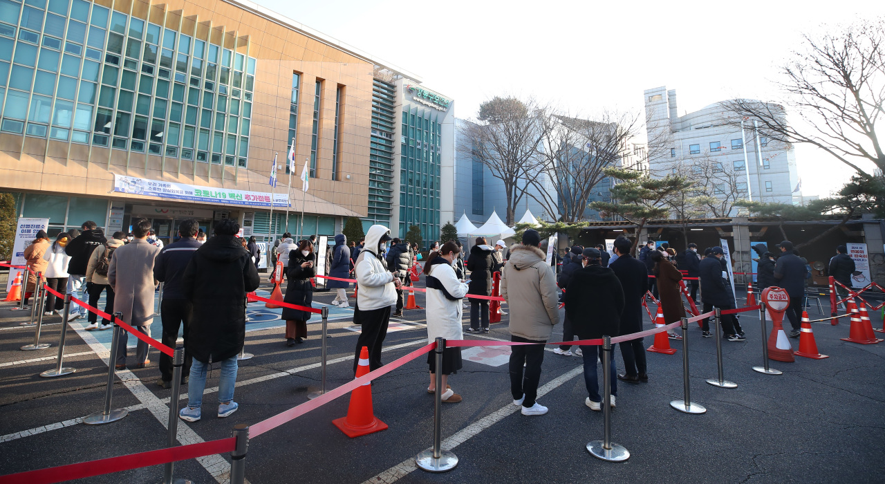 People wait in line to get tested for COVID-19 at a makeshift clinic in Seoul on Wednesday. (Yonhap)
