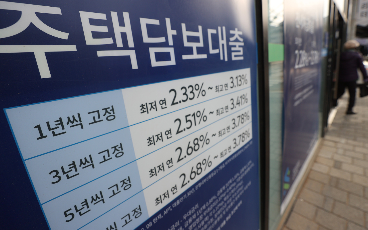 This photo, taken Monday, shows a sign put up in front of a bank in Seoul that reads information about its mortgage loan programs. (Yonhap)