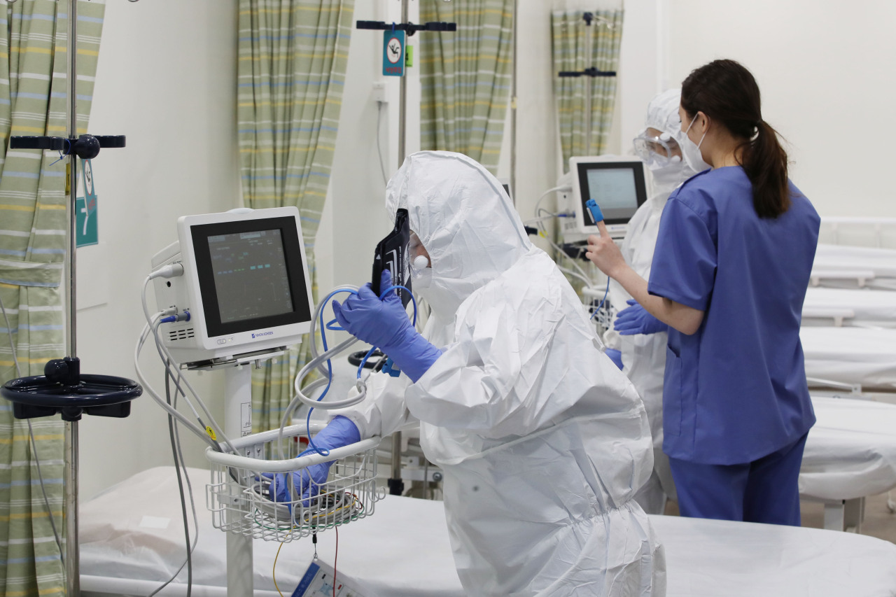 Medical workers check equipment at a COVID-19-only hospital in Seoul on Monday, when the country reported 4,207 new cases. (Yonhap)