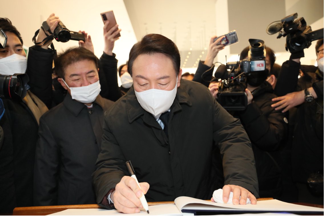Yoon Suk-yeol, the presidential candidate of the main opposition People Power Party, signs a guestbook during a visit to the Sinam National Cemetery in Daegu, 300 kilometers southeast of Seoul, on Thursday. (Yonhap)