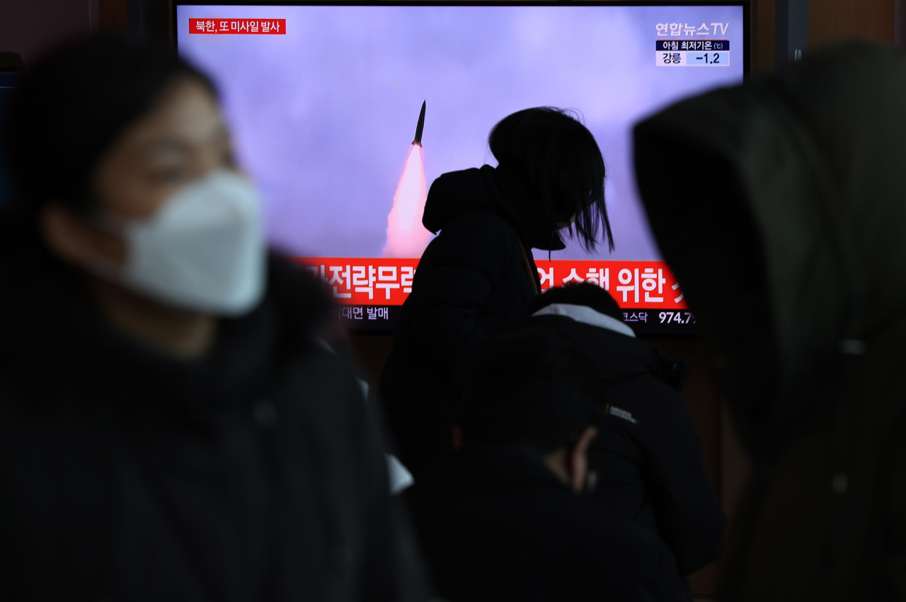 South Korean citizens watch a TV news report on North Korea's launch of a ballistic missile at Seoul Station in central Seoul on Tuesday. (Yonhap)