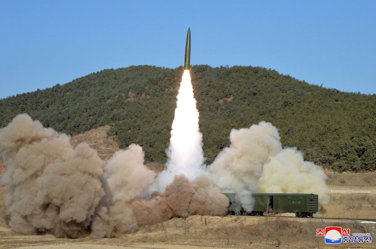 North Korea test-fires a pair of short-range ballistic missiles from a rail-mobile launcher during firing drills on Jan. 14. (KCNA-Yonhap)