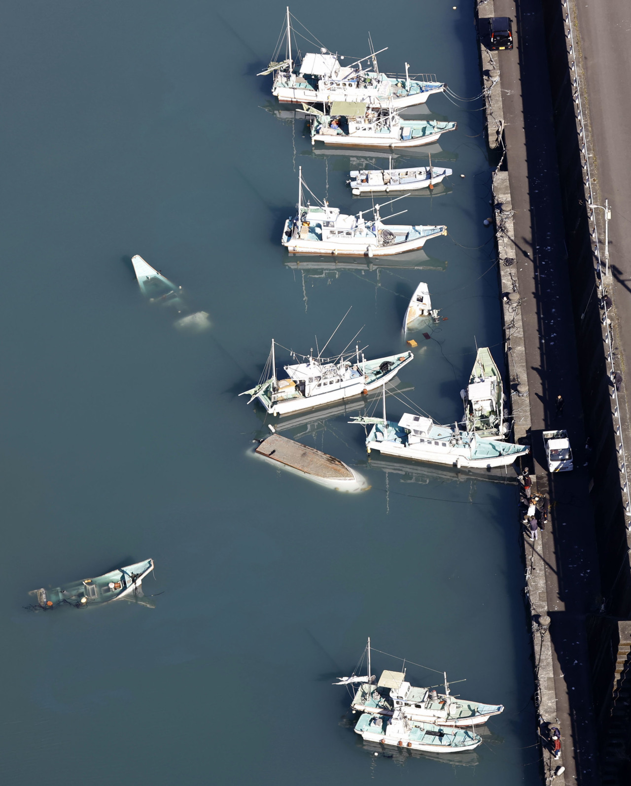 Boats capsized by a tsunami is seen on Sunday at a port in the city of Muroto, Kochi Prefecture. (Yonhap)