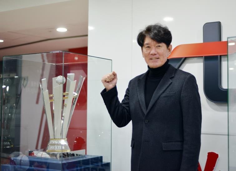 KT Wiz manager Lee Kang-chul poses next to the team's 2021 Korean Series trophy at KT Wiz Park in Suwon, around 45 kilometers south of Seoul, on Monday. (Yonhap)