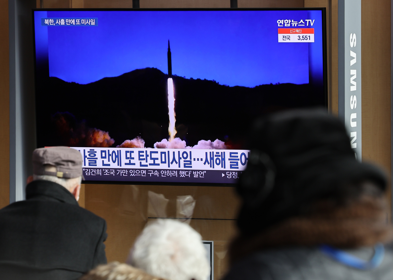 South Korean citizens watch a TV news report on North Korea's launch of a ballistic missile at Seoul Station in central Seoul on Monday. (Yonhap)