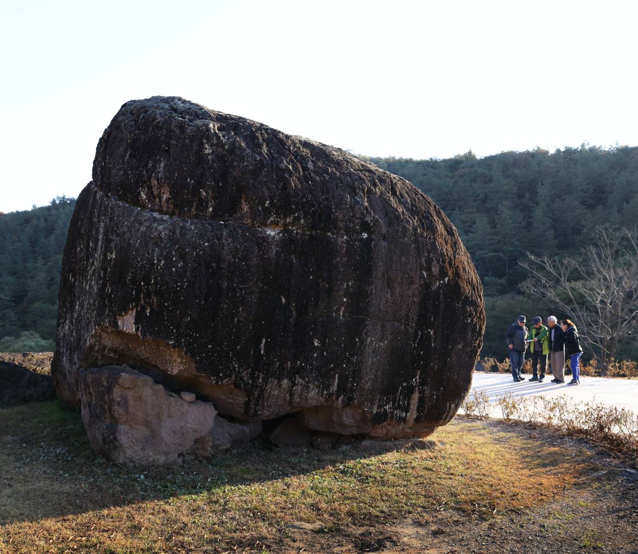 Visitors are dwarfed next to the Pingmaebawi Dolmen, which weighs approximately 200 tons, in Hwasun Dolmen site in South Jeolla Province. Photo © Hyungwon Kang
