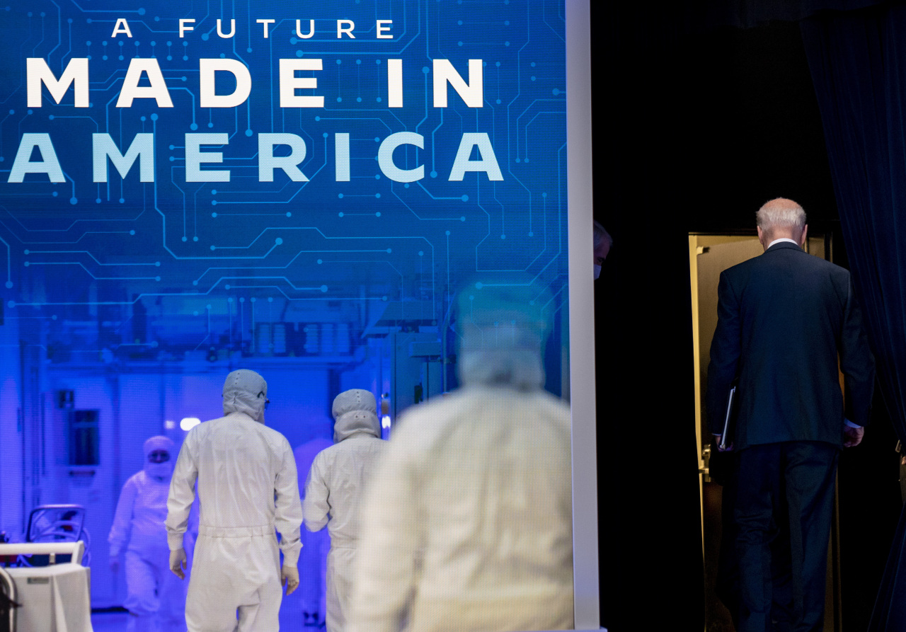 President Joe Biden leaves after speaking about Intel’s announcement to invest in an Ohio chip making facility, at the South Court Auditorium in the Eisenhower Executive Office Building on the White House Campus in Washington Friday. (AP-Yonhap)