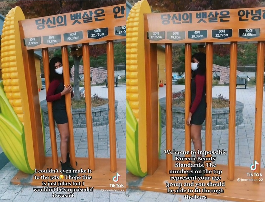 Diana Nordeus, a 20-year-old American college student in Seoul, tries to fit through the bars of a wooden installation at a highway rest area in Hongcheon, Gangwon Province, that shows the ideal waist widths for different age groups, in September 2021. (Diana Nordeus)
