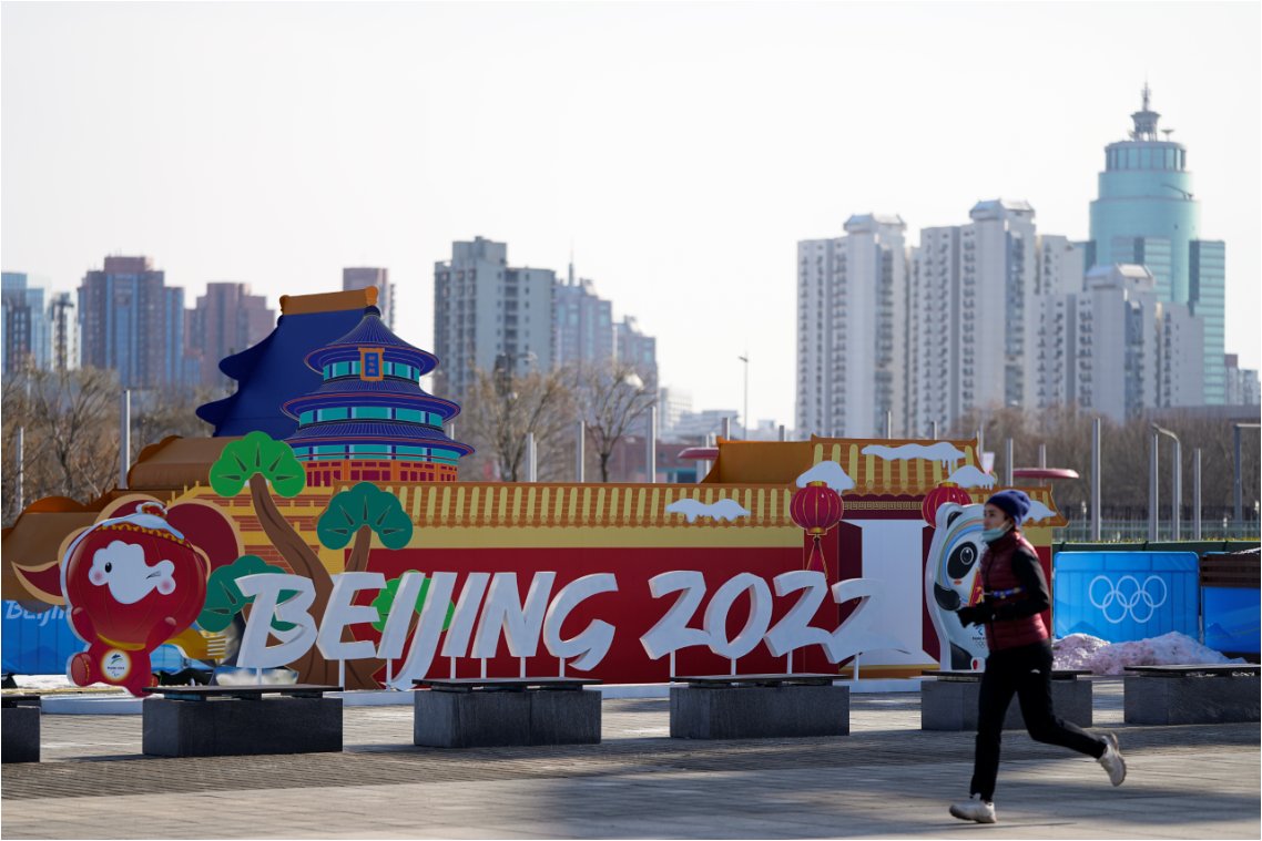 This Associated Press photo shows a jogger in front of an installation near the Beijing Olympic Park in Beijing on Tuesday. (Yonhap)