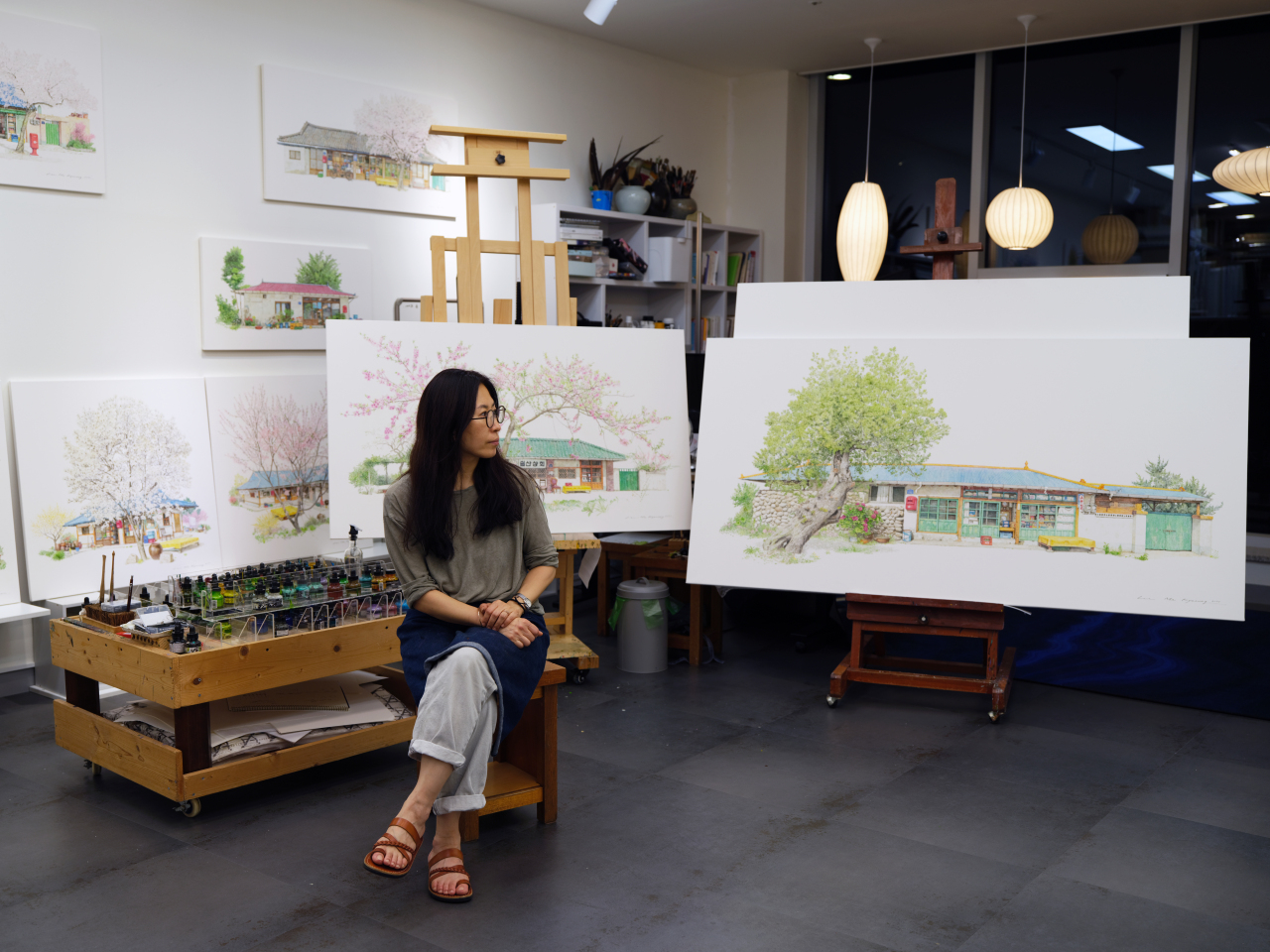 Lee Me-kyeoung sits in front of her painting in her studio in Hanam city, Gyeonggi Province. (Lee Me-kyeoung)