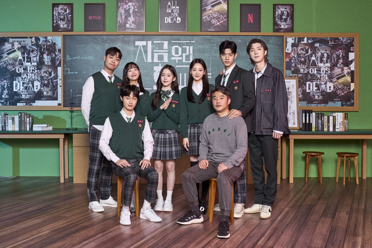 From top left, clockwise: Actors Lim Jae-hyeok, Lee Yoo-mi, Park Ji-hu, Cho Yi-hyun, Lomon, Yoo In-soo, director Lee Jae-kyoo and actor Yoon Chan-young pose for a photo before an online press conference Wednesday. (Netflix)