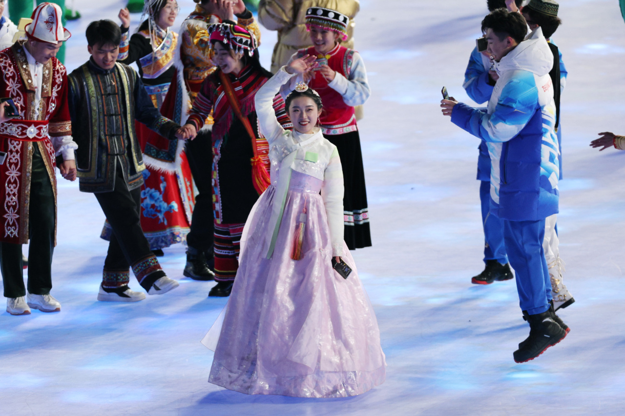 A Chinese performer dressed in hanbok, traditional Korean attire, waves during the opening ceremony of the 2022 Beijing Winter Olympics held at the National Stadium in Beijing, Friday. (Yonhap)