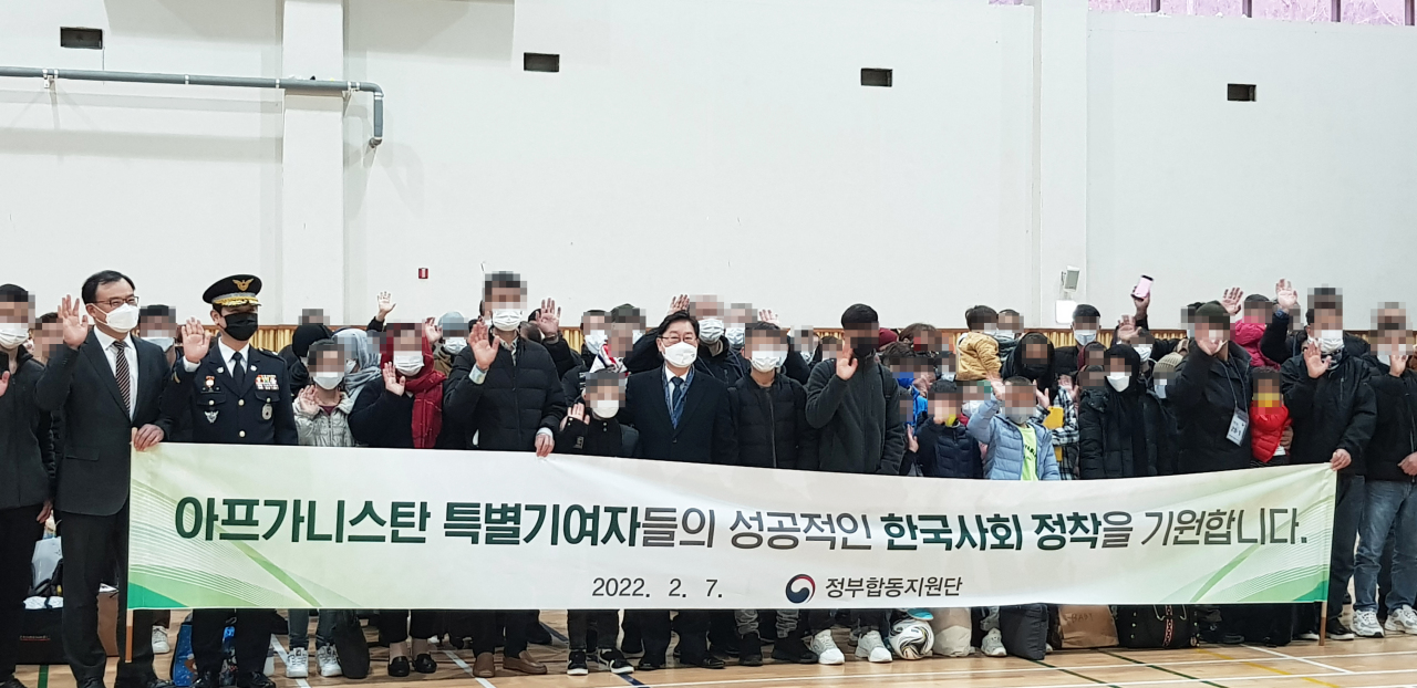 This photo, provided by the Ministry of Justice on Monday, shows Justice Minister Park Beom-kye and Afghan evacuees taking a picture before leaving the temporary evacuee residence in the southwestern city of Yeosu. (Ministry of Justice )