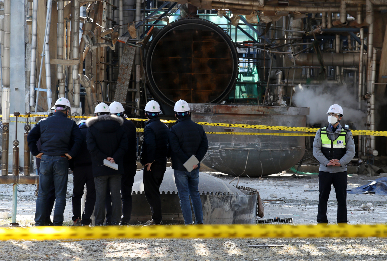 Last Friday, file photo shows police officials examining the scene of a factory explosion in the southern city of Yeosu that left four workers dead and four others injured. (Police officials)