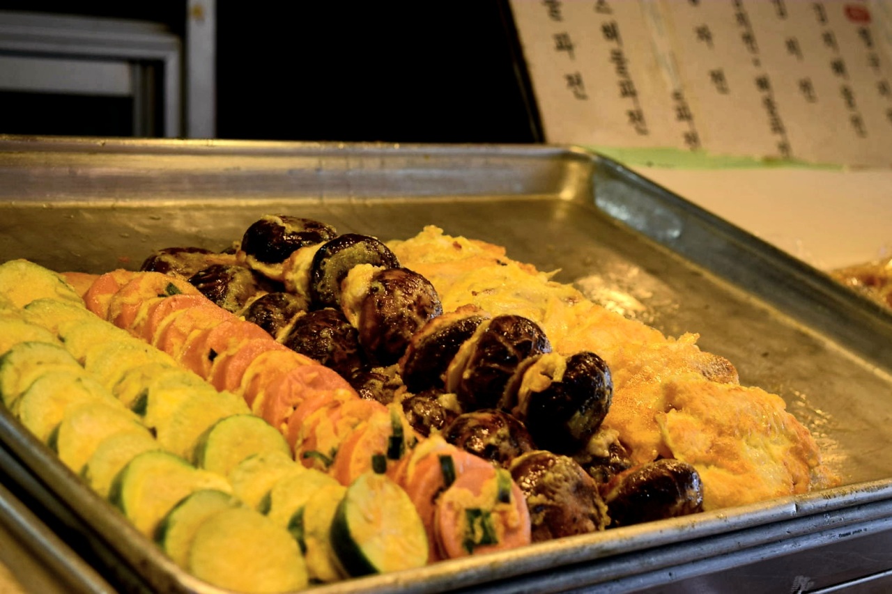 Different types of jeon, or buchimgae, are neatly stacked on trays. (Kim Hae-yeon/The Korea Herald)
