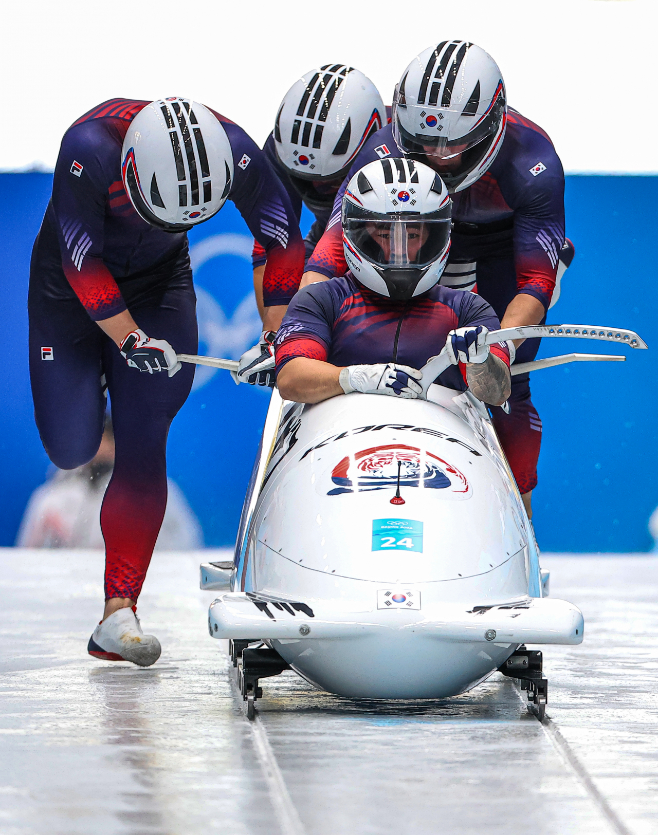 In this Associated Press photo, a South Korean bobsleigh team, piloted by Won Yun-jong (front), comes to the finish area after the third run of the four-man competition at the Beijing Winter Olympics at Yanqing National Sliding Centre in Yanqing District, northwestern Beijing, on Sunday. (Yonhap)