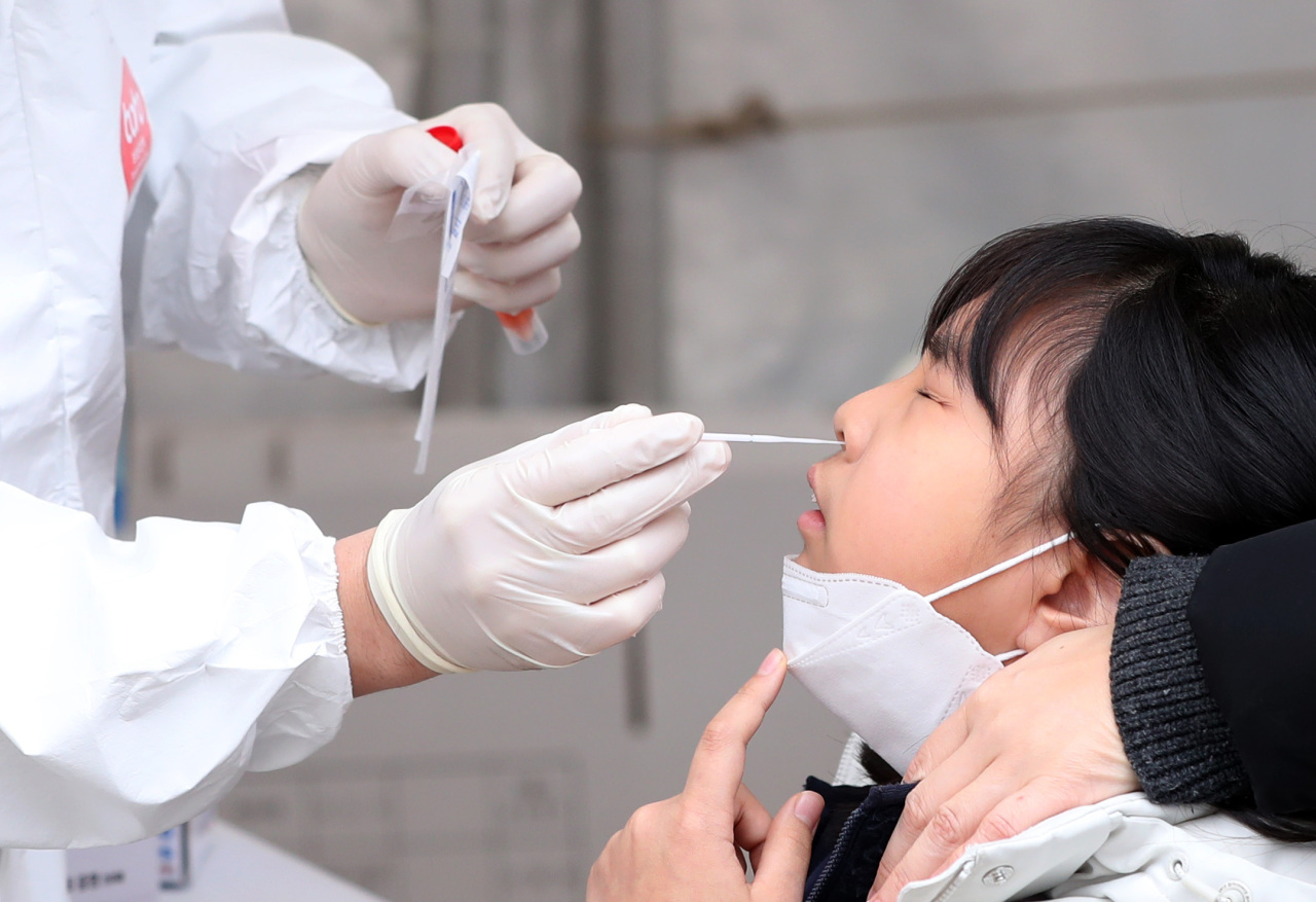 A child is being tested of COVID-19 at a makeshift testing center in Chuncheon, Gangwon Province, Monday. (Yonhap)
