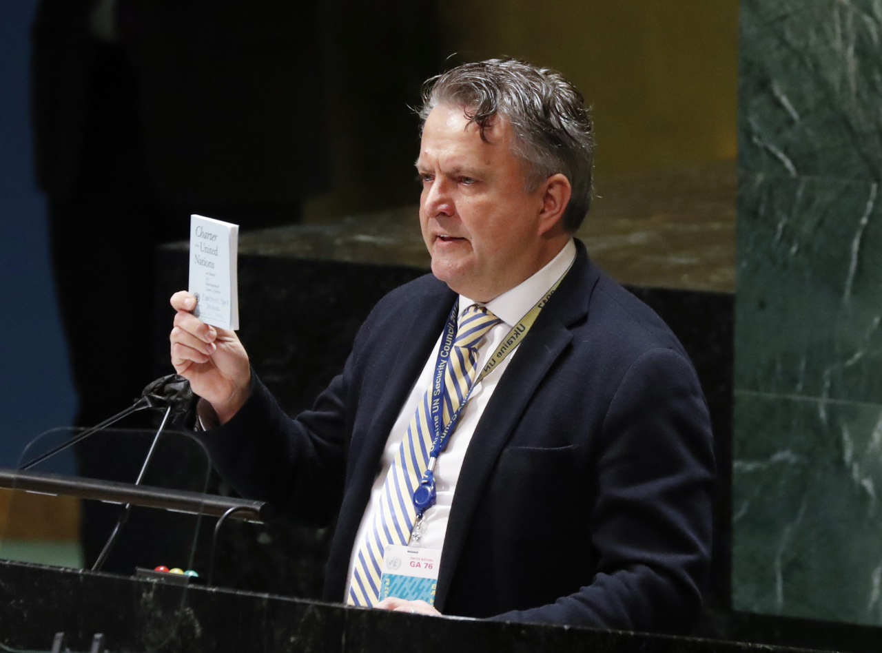 Ukraine Ambassador to the United Nations Sergiy Kyslytsya holds up the Charter Of The United Nations hand book while speaking as the Eleventh Emergency Special Session on the Ukraine Russia conflict continues in General Assembly Hall at United Nations Headquarters in New York City on Wednesday. Russian forces are continuing their attempted push through Ukraine from multiple directions. Photo by John Angelillo. (UPI-Yonhap)