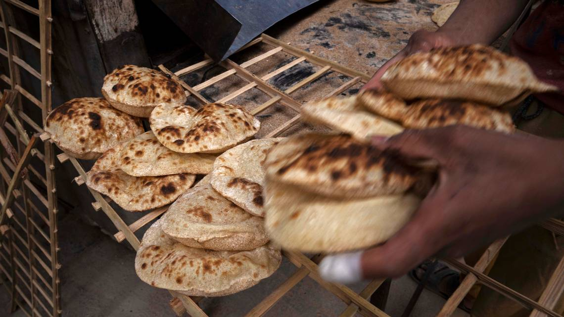 A worker collects Egyptian traditional 'baladi' flatbread, at a bakery, in el-Sharabia, Shubra district, Cairo, Egypt, last Wednesday. The Russian tanks and missiles besieging Ukraine also are threatening the food supply and livelihoods of people in Europe, Africa and Asia who rely on the vast, fertile farmlands of the Black Sea region. That could create food insecurity and throw more people into poverty in places like Egypt and Lebanon, where diets are dominated by government-subsidized bread. (AP Photo/Nariman El-Mofty)