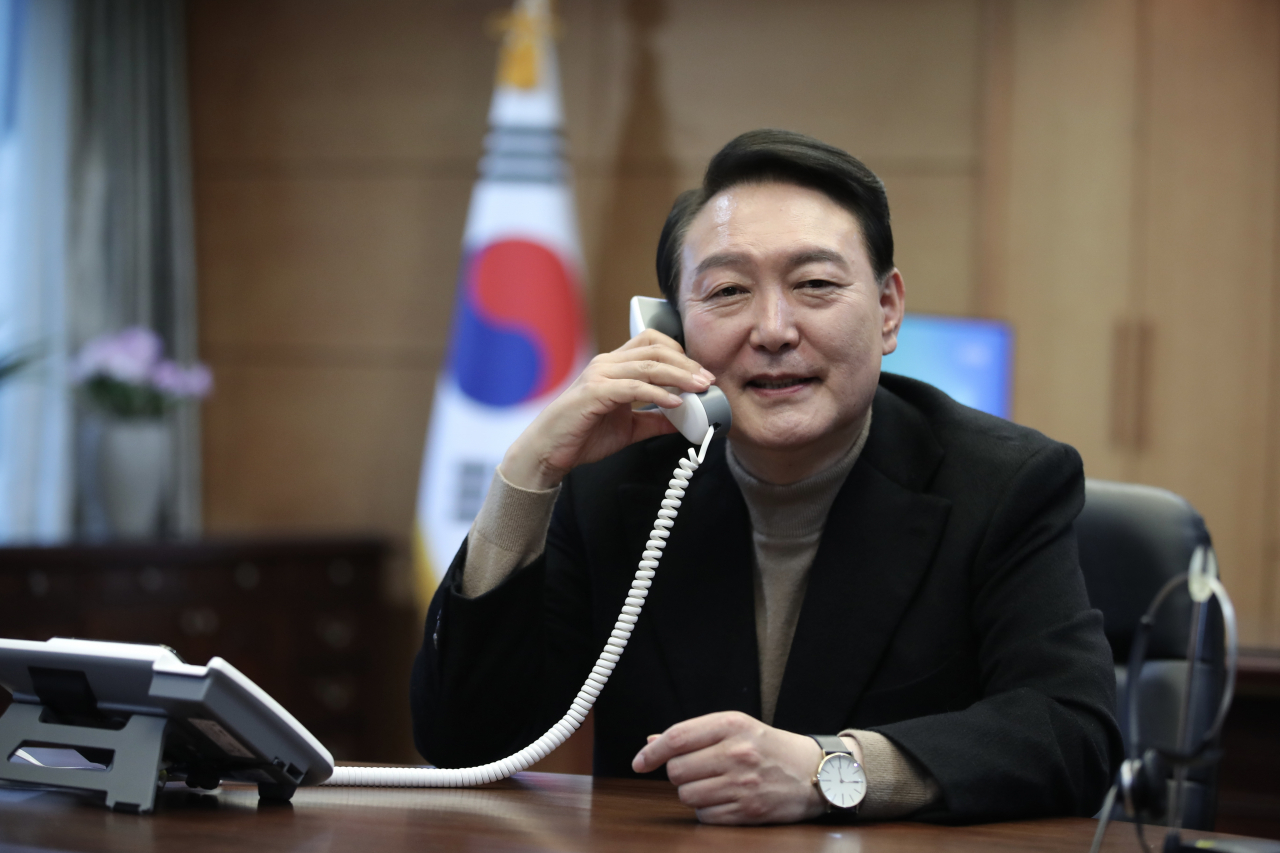This photo provided by the People Power Party (PPP) on Tuesday, shows President-elect Yoon Suk-yeol speaking with British Prime Minister Boris Johnson over the phone at his office in Seoul. (PPP)