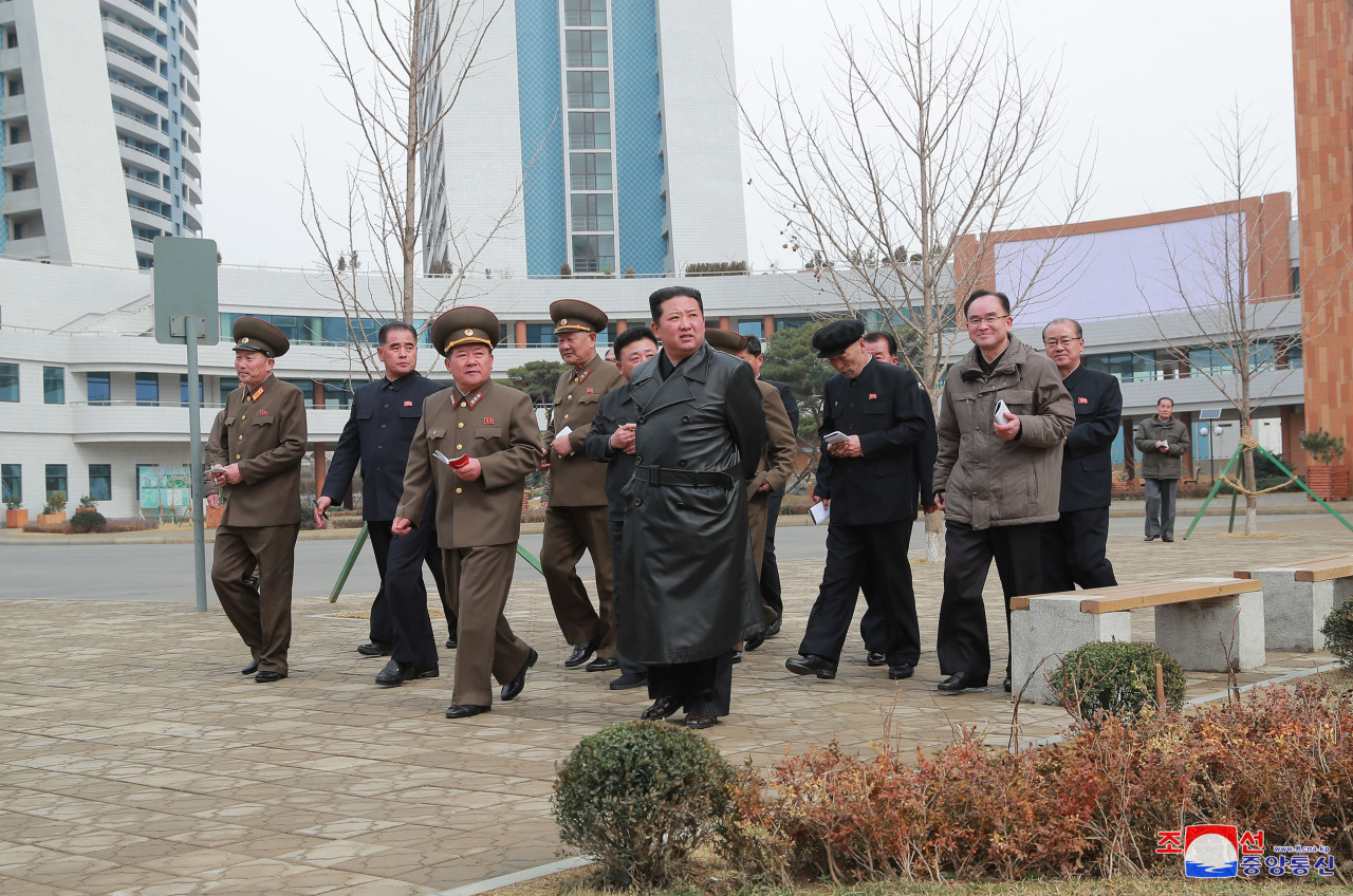 North Korean leader Kim Jong-un (center) walks around with officials to inspect a major housing construction site in Pyongyang, in this undated photo released by the North’s official Korean Central News Agency on Wednesday. (KCNA-Yonhap)