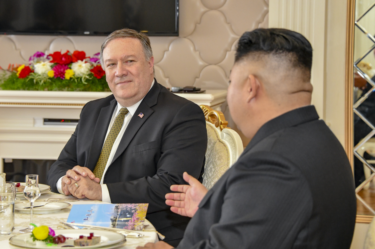 Then-US Secretary of State Michael Pompeo and North Korean leader Kim Jong-un attend a working lunch in Pyongyang on October 7, 2018. (State Department)