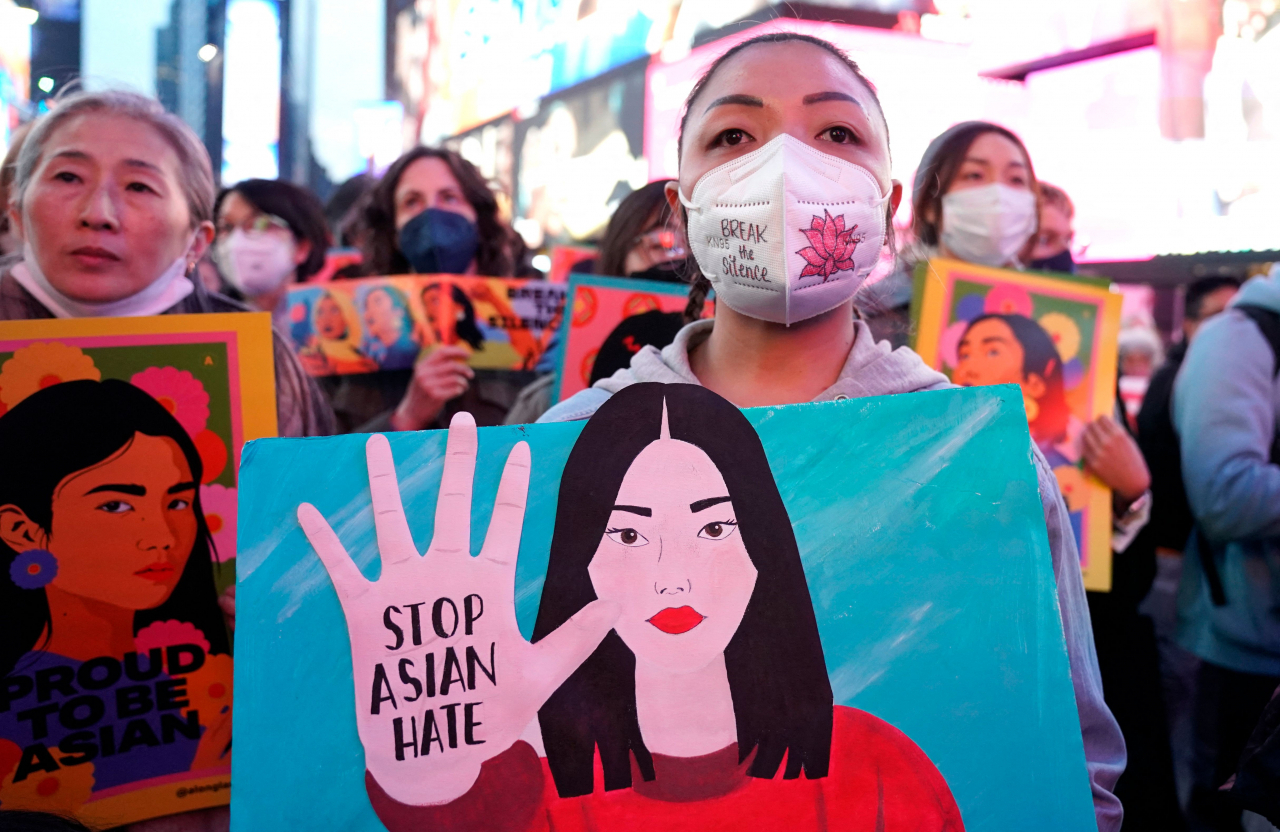 People rally calling for action and awareness on rising incidents of hate crime against Asian-Americans in Times Square in New York City on Wednesday. -- The rally is held on the 1st anniversary of the Atlanta Spa shootings. (AFP-Yonhap)