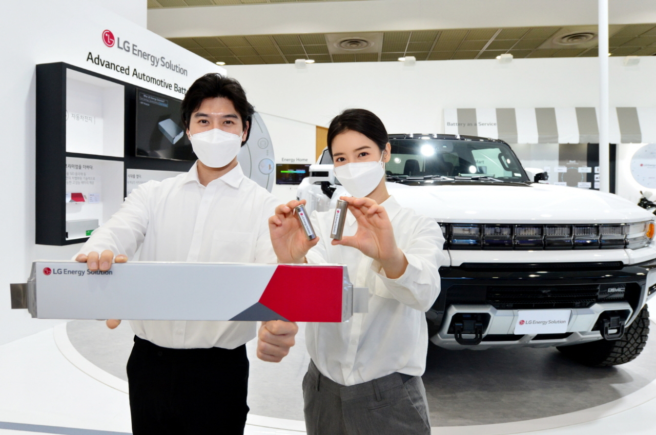 Models pose for a photo in front of GMC Hummer pickup displayed at LG Energy Solution’s exhibition at InterBattery. (LG Energy Solution)