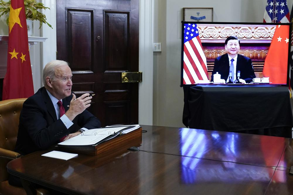 President Joe Biden meets virtually with Chinese President Xi Jinping from the Roosevelt Room of the White House in Washington, on Nov. 15, 2021. (AP Photo/Susan Walsh)