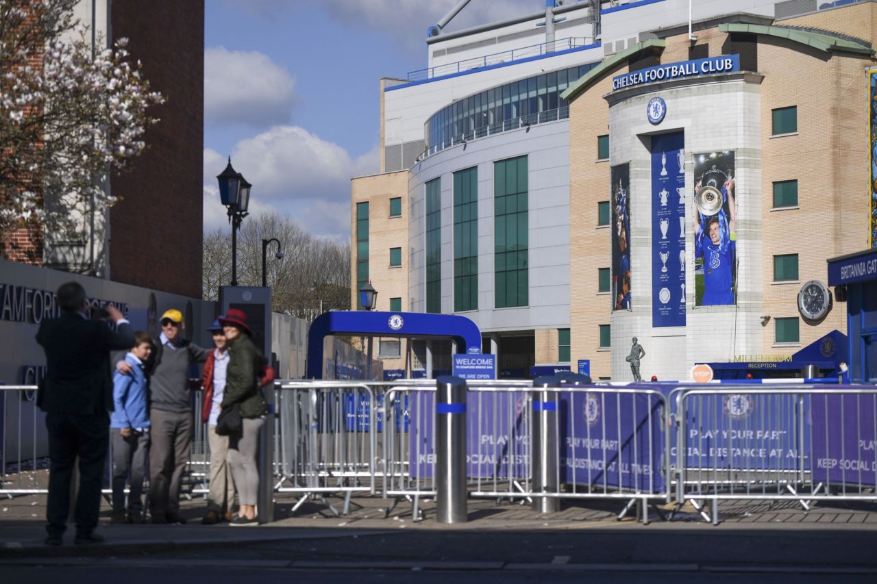 Visitors have their picture taken at Stamford Bridge Stadium, home of the Chelsea Football Club, in London, Friday. (Bloomberg)