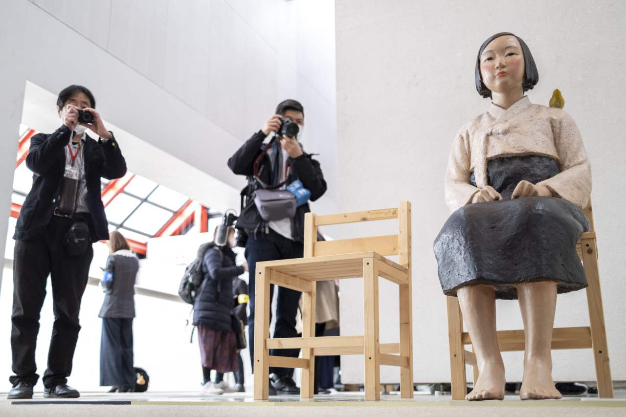 Journalists attend a preview of an exhibition of statues of 