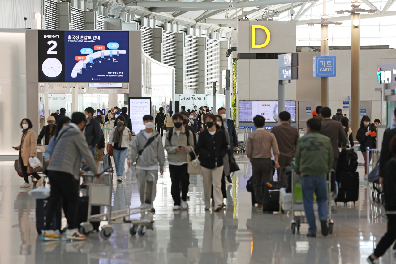 This photo taken on Friday, shows outbound travelers at Incheon International Airport in Incheon, just west of Seoul, amid eased social distancing rules. (Yonhap)