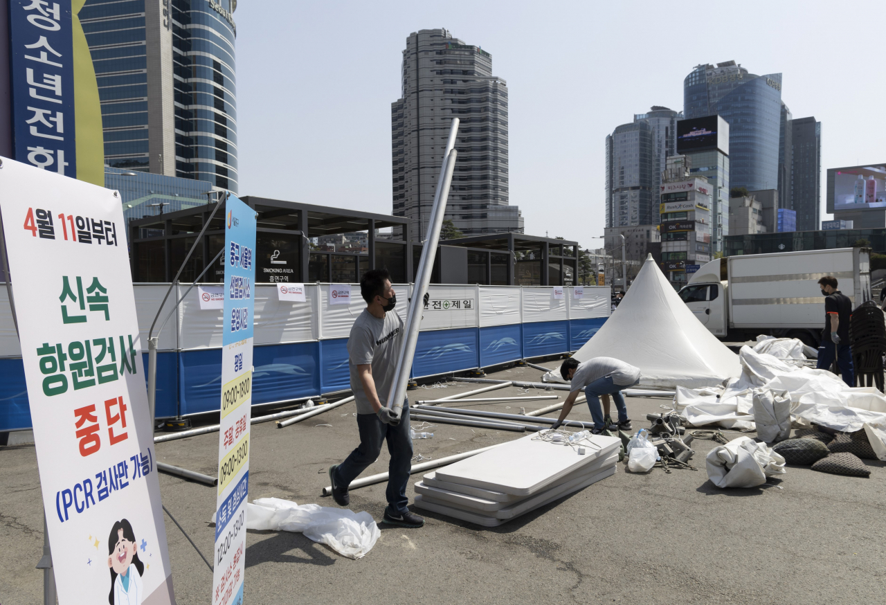 Some COVID-19 testing tents at Seoul Station are being disassembled on Sunday, as all makeshift COVID-19 testing booths will stop carrying out free rapid antigen tests and only provide polymerase chain reaction tests for potential patients in high-risk groups starting April 11. (Yonhap)