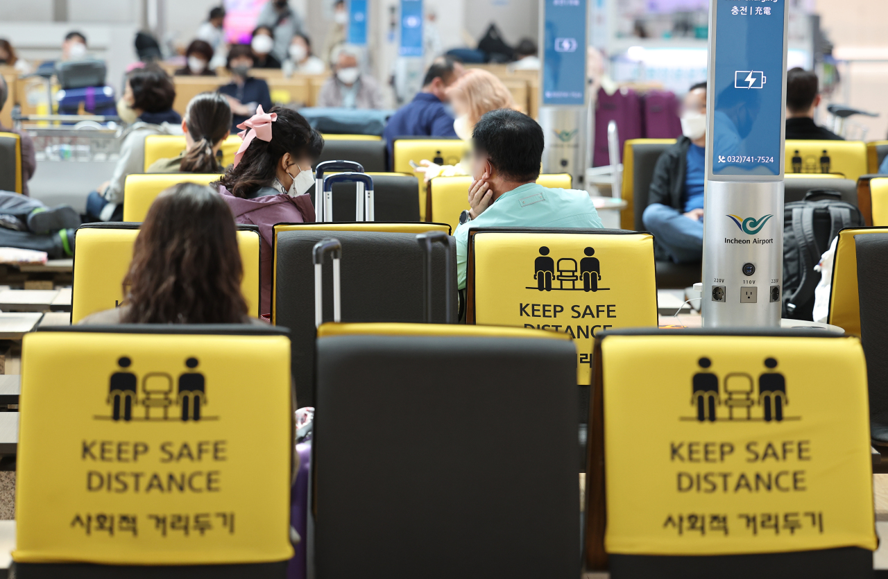 Signs on seats at Incheon Airport ask passengers to socially distance. (Yonhap)