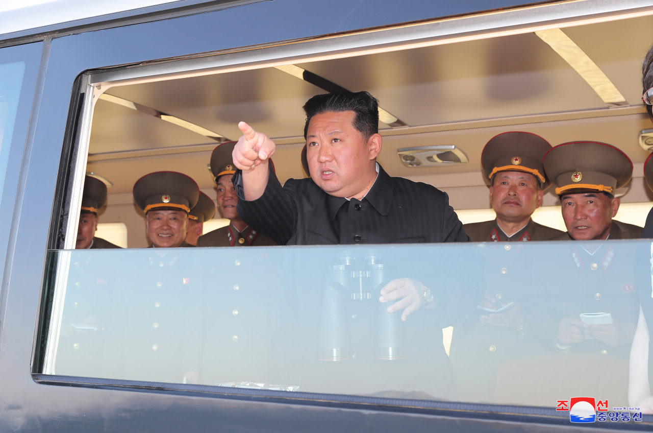 North Korean leader Kim Jong-un oversees the test-firing of a new tactical guided missile in a photo released by North Korea‘s state-run Korean Central News Agency on Sunday. (Yonhap)