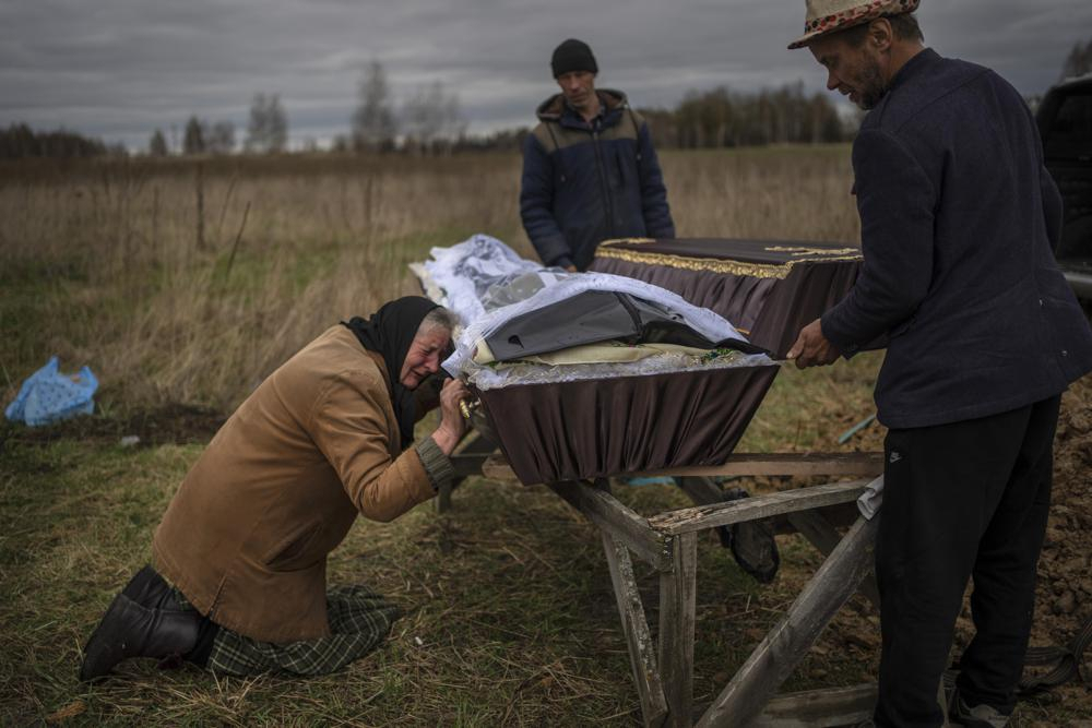 Nadiya Trubchaninova, 70, cries while holding the coffin of her son Vadym, 48, who was killed by Russian soldiers last March 30 in Bucha, during his funeral in the cemetery of Mykulychi, on the outskirts of Kyiv, Ukraine, Saturday. (AP)